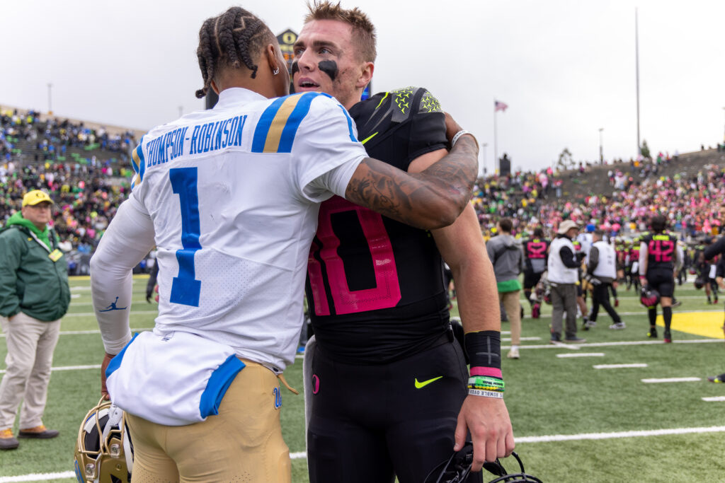 Quarterback Bo Nix of the Oregon Ducks shakes hands with Quarterback Dorian Thompson-Robinson of the UCLA Bruins